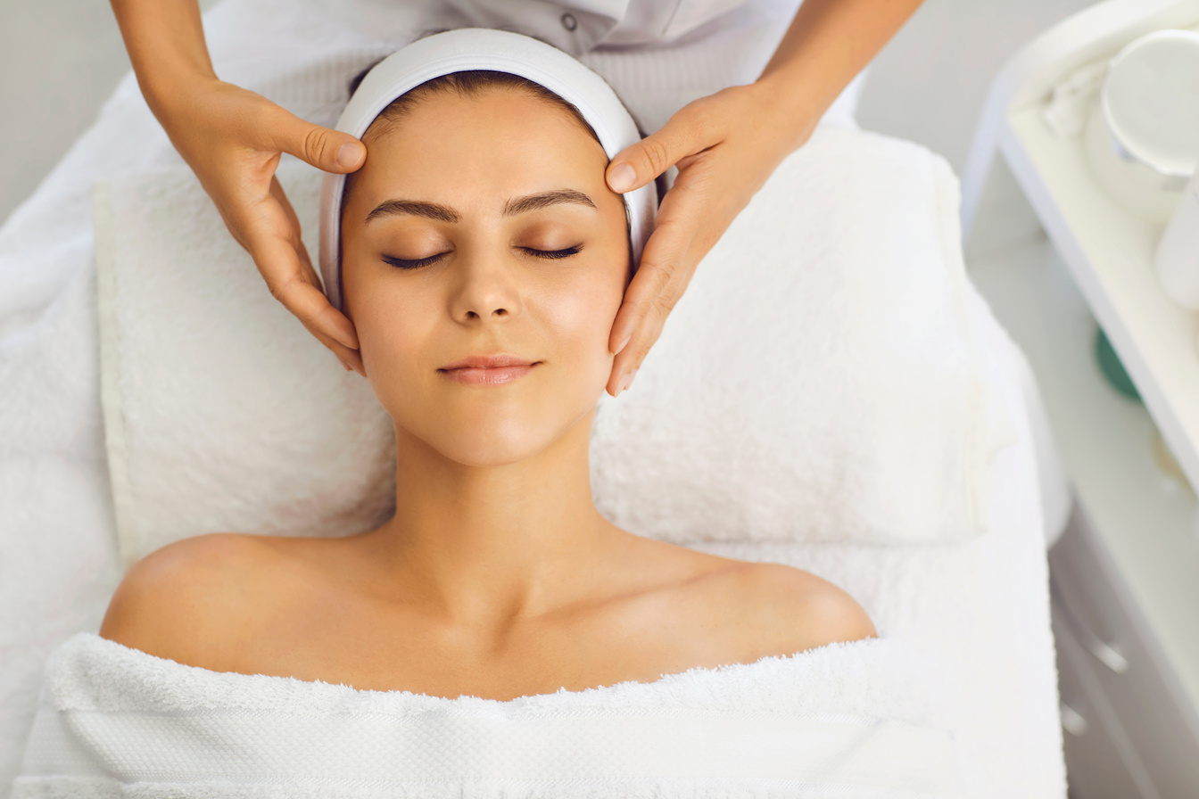 Female Face Massage in a Beauty Salon. Beautician Makes Facial Skin Treatment in a Beauty Clinic