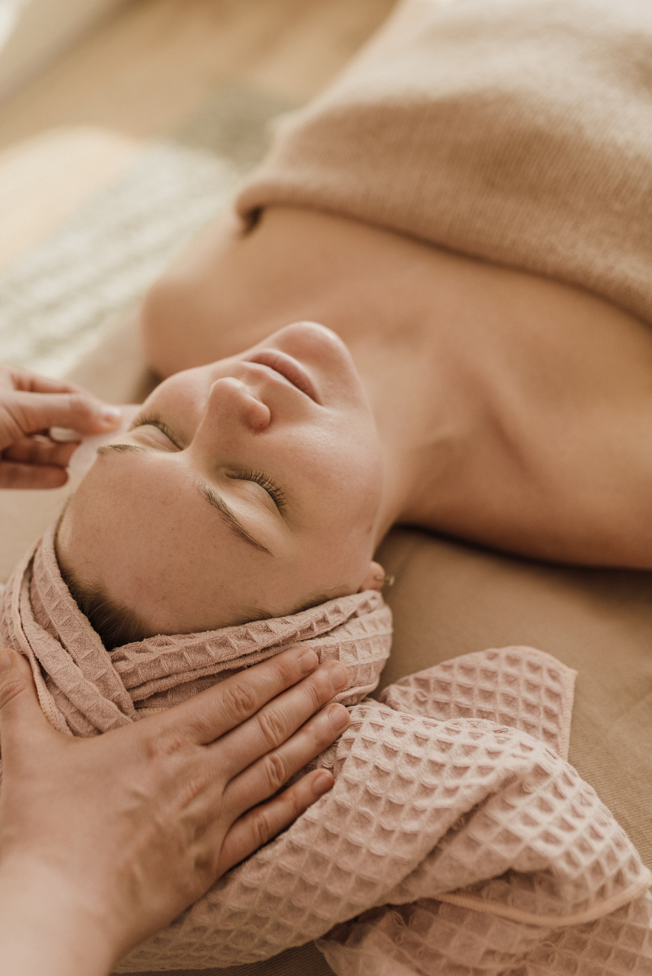  A Person Using a Gua Sha on a Woman's Face